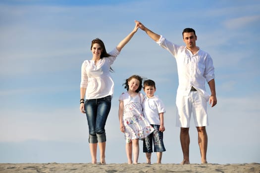 happy young family have fun and live healthy lifestyle on beach