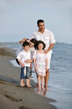 happy young family have fun and live healthy lifestyle on beach