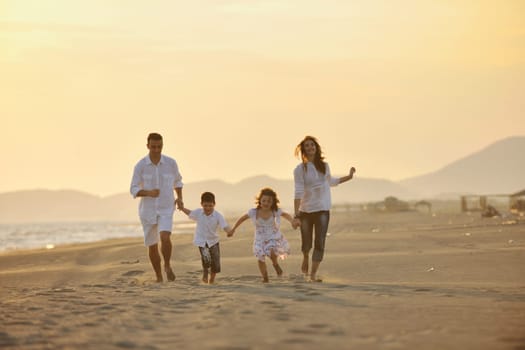 happy young family have fun and live healthy lifestyle on beach