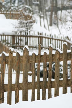 Wooden fence in the snow