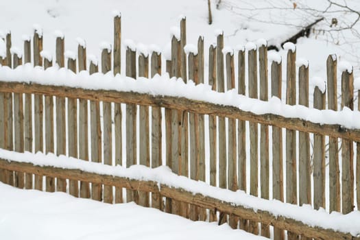 Wooden fence in the snow