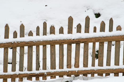 Wooden fence in the snow