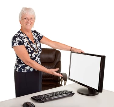 A senior businesswoman is pointing with her hand at a blank monitor.