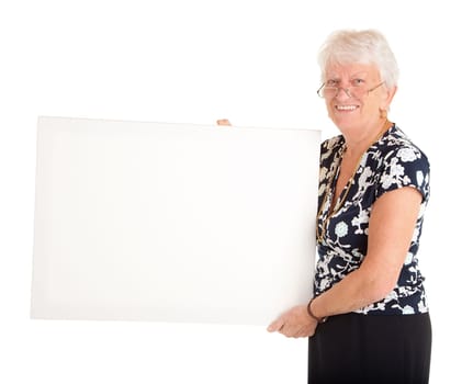 A senior businesswoman is holding a blank white sign.