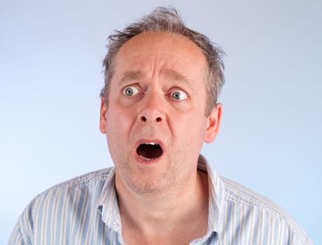 The face of a man being afraid of something.