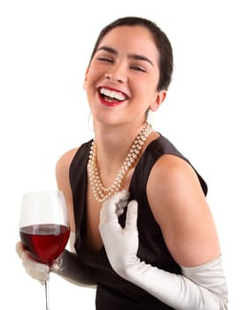 A beautiful woman is holding a glass of wine and laughing.