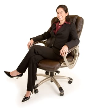 A smiling businesswoman is sitting on a leather chair.