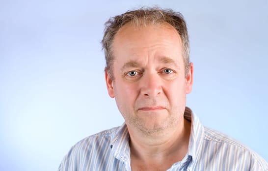 A middle-aged man is depressed or unhappy about something.