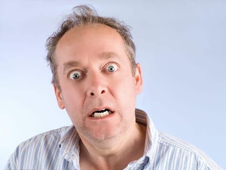 A man is scared or surprised of something.
