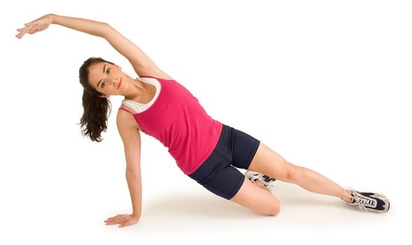 A young beautiful woman is exercising and stretching.