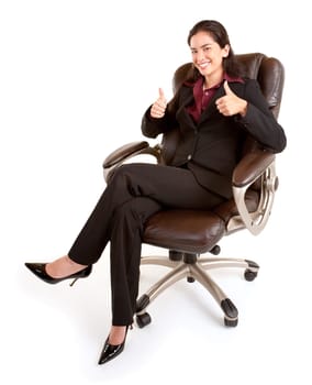 A businesswoman is sitting on a leather chair with her thumbs up.