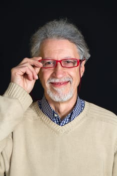 Portrait of a happy mature man isolated on black background