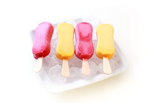 Fruit sorbet as popsicle on ice
