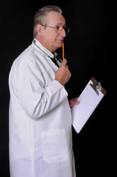Senior doctor wearing a stethoscope isolated on black