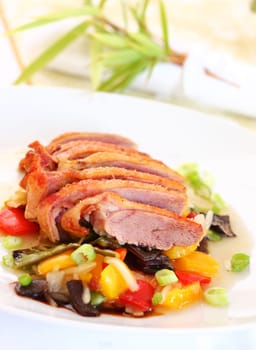 Delicious roasted duck on vegetables