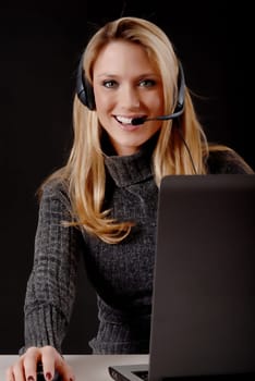 Lovely blond business woman working at laptop computer
