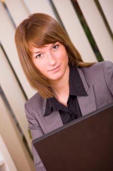 portrait of woman working in office with laptop
