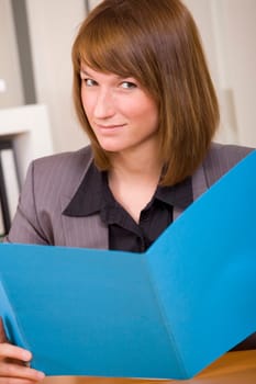 business woman holding and reading an application file