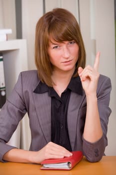 business woman with diary pointing finger