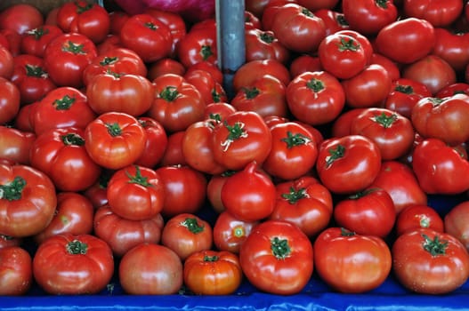 Fresh tomatoes for sale at grocery store. Vegetables background.