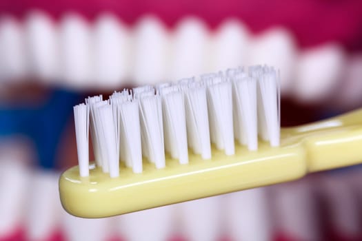 Brushing your teeth with a toothbrush