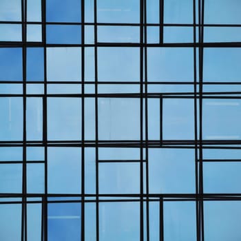 Abstract facade lines and glass reflection on modern building. Architectural detail.