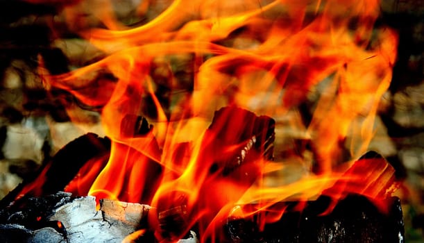 Dry wood burns slowly in the grill