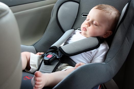 little baby sleeping peacefully in the car seat