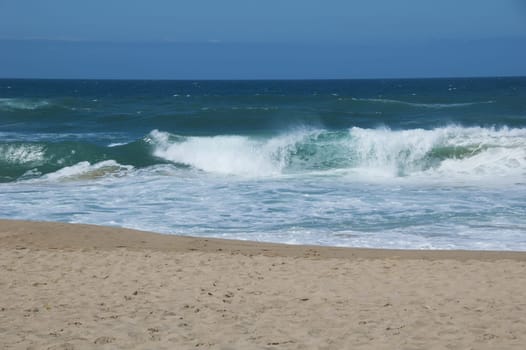 Beach: blue ocean with big waves and sand