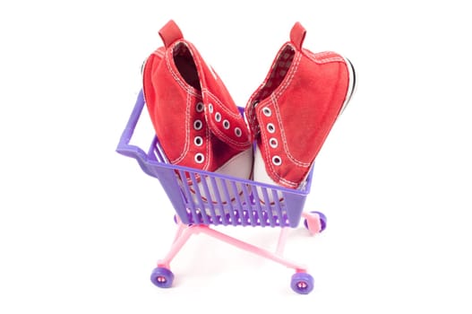 Conceptual photo with miniature shopping-cart isolated on white