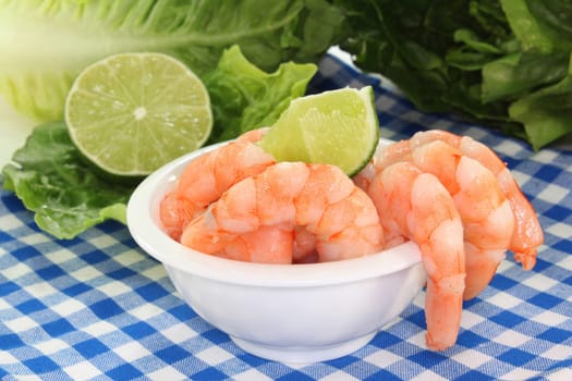 fresh prawns and lime against white background