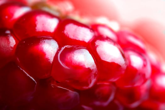 A closeup macro image of pomegranate seeds