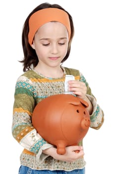 adorable girl putting its savings in your money box