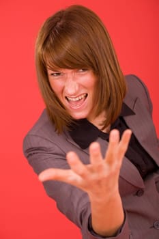 frustrated woman in grey suit over red background