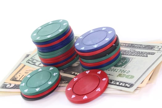 Colorful chips and dollar bills against white background