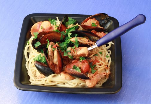 a dish with spaghetti with seafood