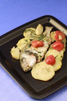 dish with gilthead with tomatoes and potatoes
