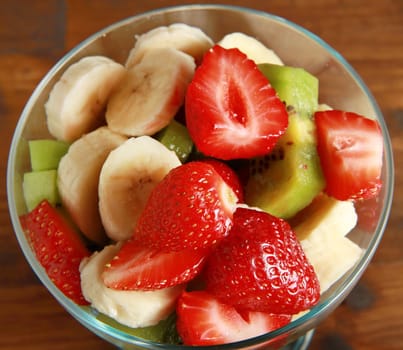 Fresh fruits salad on wooden table