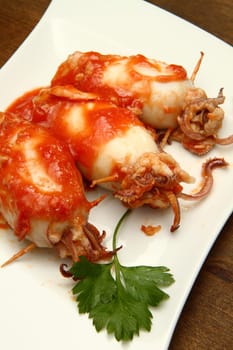 a dish with calamari tomatoes