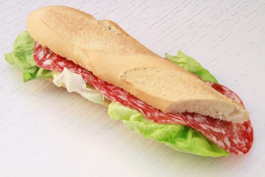 a salami roll with lettuce