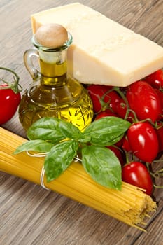 spaghetti ingredients with fresh tomatoes, basil and parmesan cheese