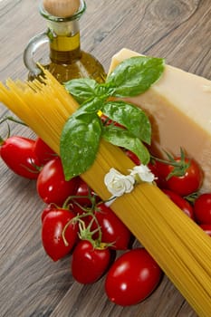 spaghetti ingredients with fresh tomatoes, basil and parmesan cheese