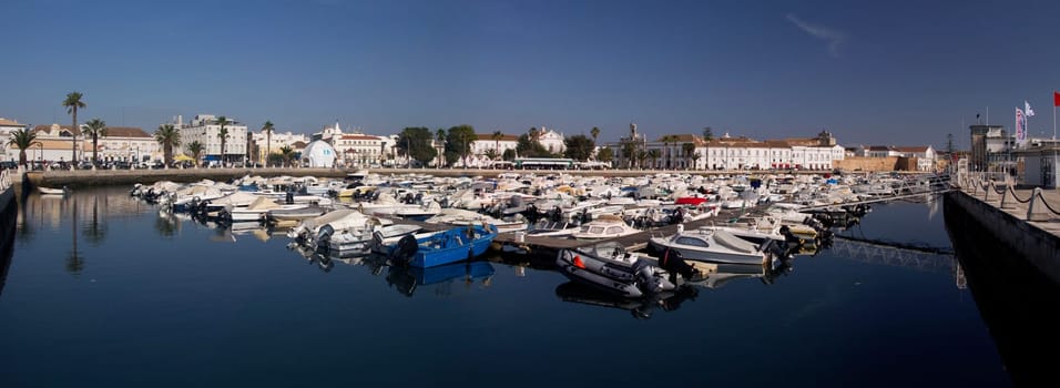 View of the marina with traditional fishing boats on Faro,  Portugal.