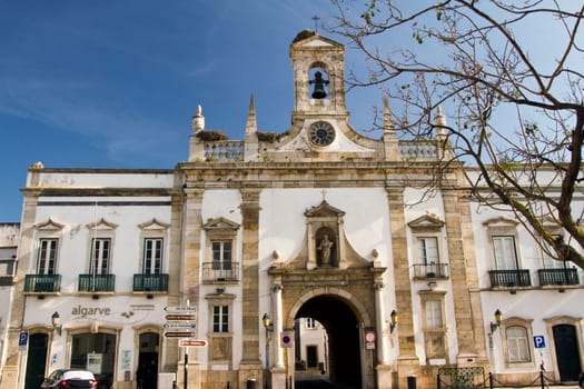 View of the main recreational plaza and Arc of Vila on the city of Faro, Portugal