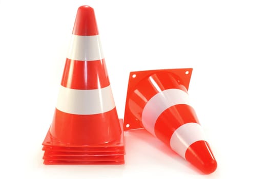 six pylons against white background