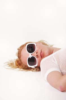 prtty girl in sunglasses lying back