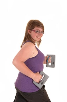 A young brunet teenager doing exercises with hand weights and walking, smiling into the camera, for white background.