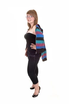 Young teenager with a striped jacket over her shoulder, in jeans and high heels standing for white background in the studio.
