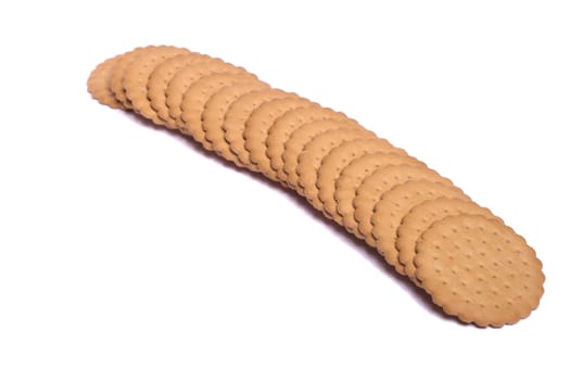 View of many round biscuits isolated on a white background.