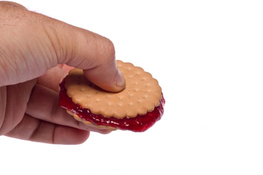 View of a round biscuit isolated on a white background with berry jam.